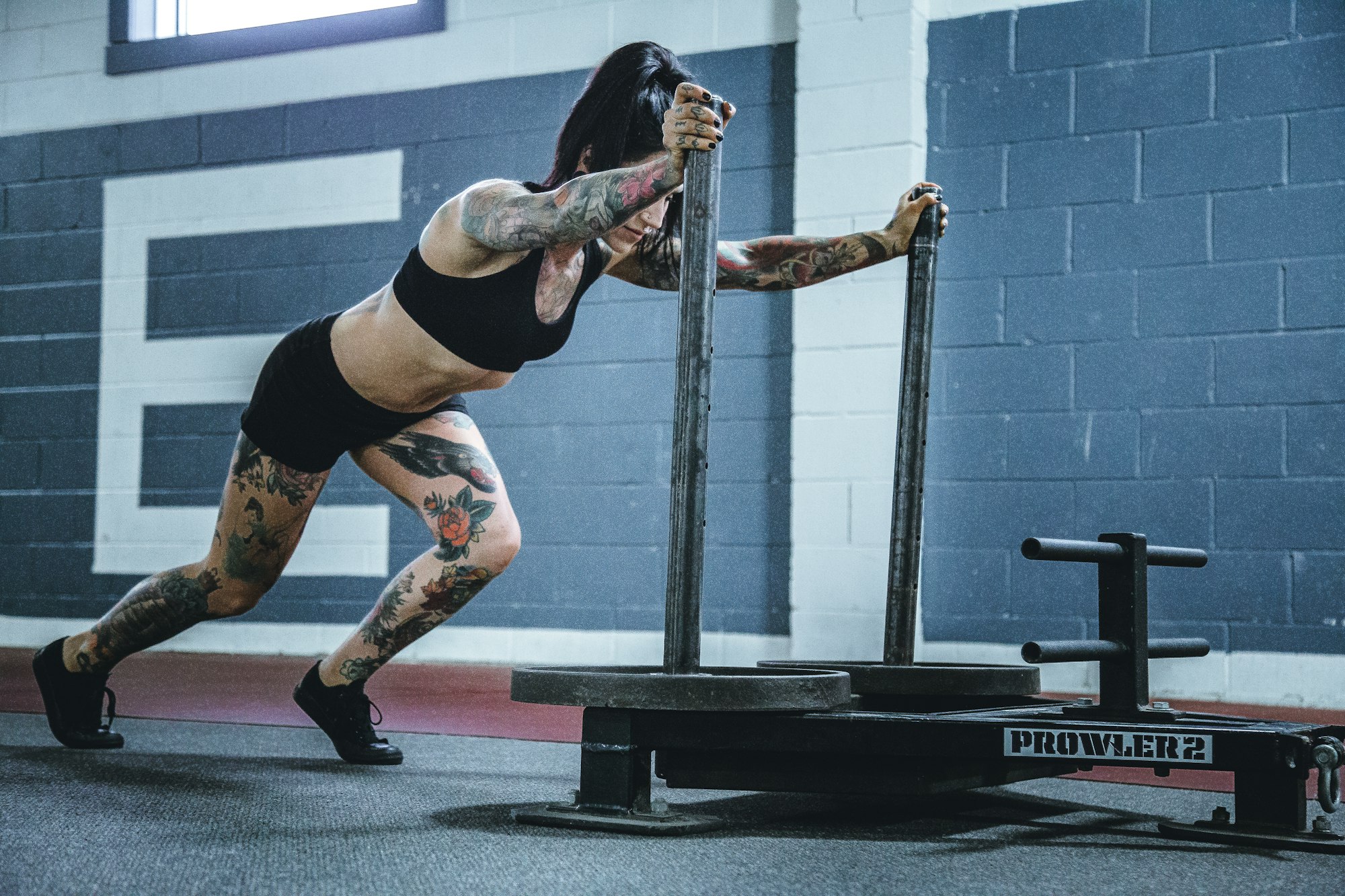 Athlete driving a loaded sled