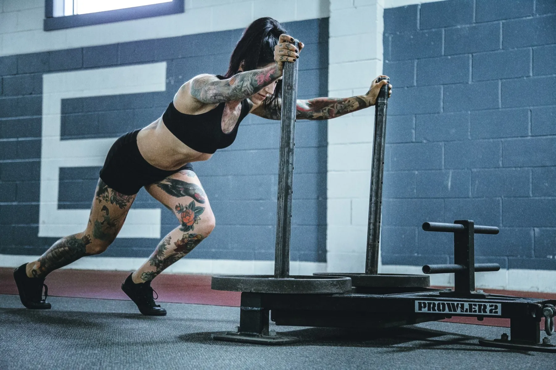Athlete driving a loaded sled